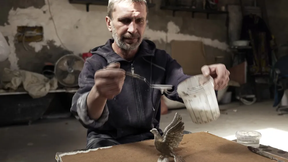 An artisan working on a sculpture
